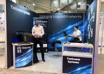 Stand for Yancomm, 3 walls, reception counter, display counter and bar table/stools with 2 staff