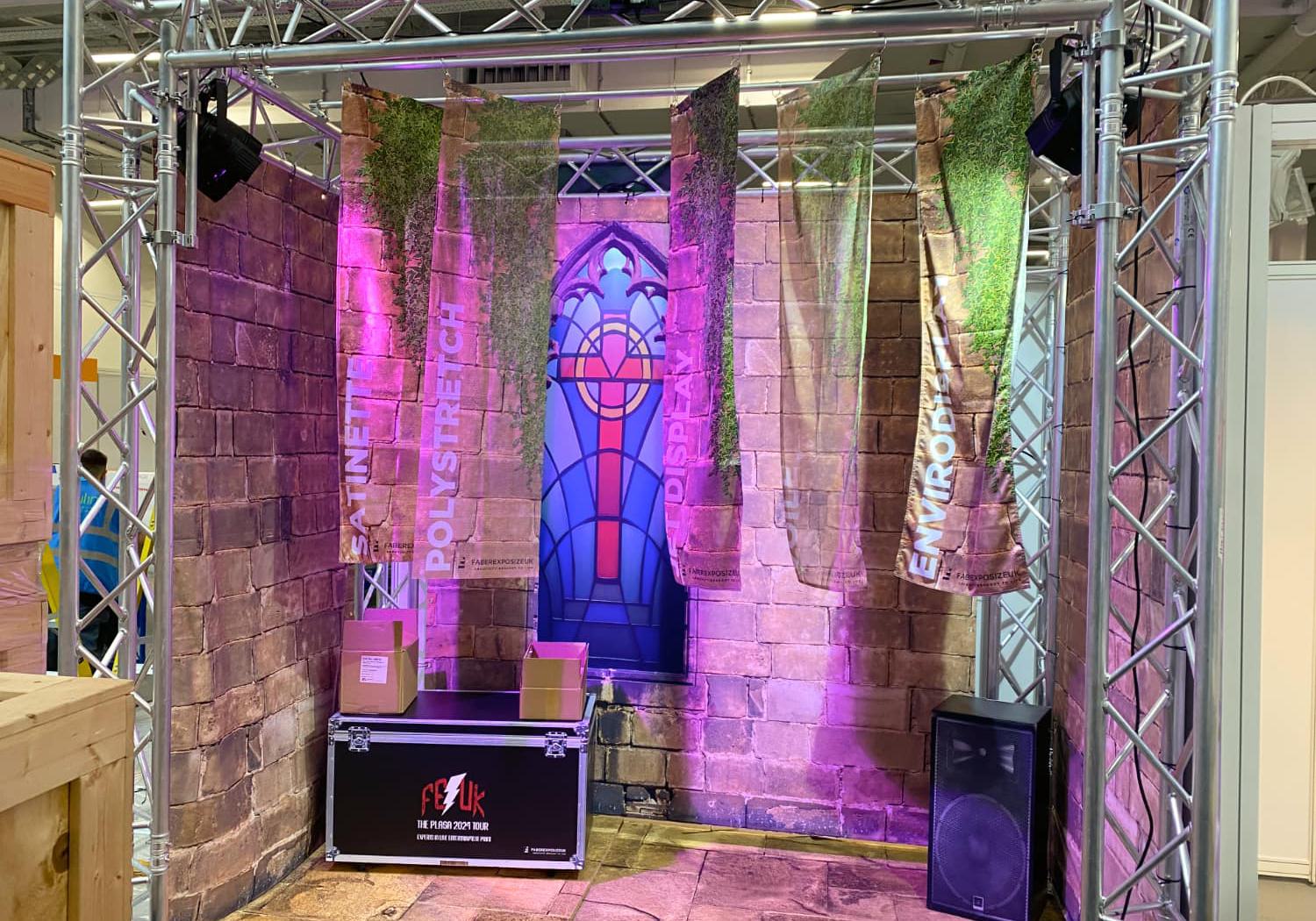 FE UK stand, aluminium rigging surround, with fabric draped walls on 3 sides