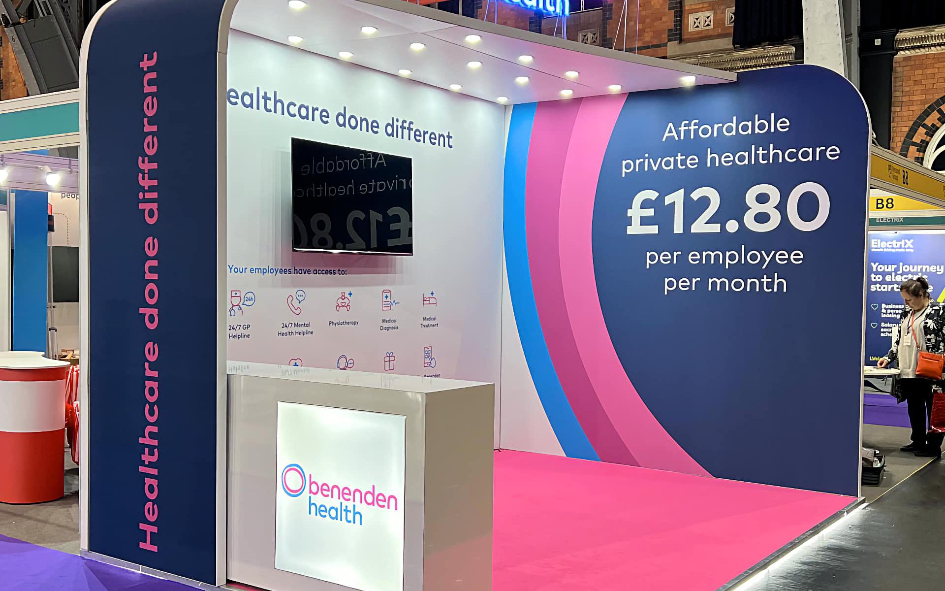 Benenden Health stand, 2 walls, arched, angled roof with downlight, and lightbox counter